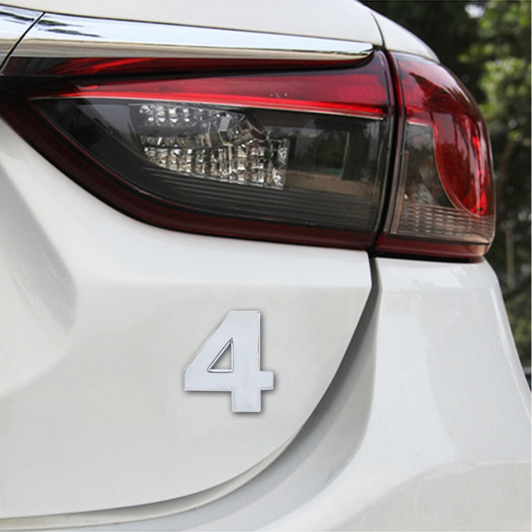 3D car number decal sticker with silver “4” on a white car panel
