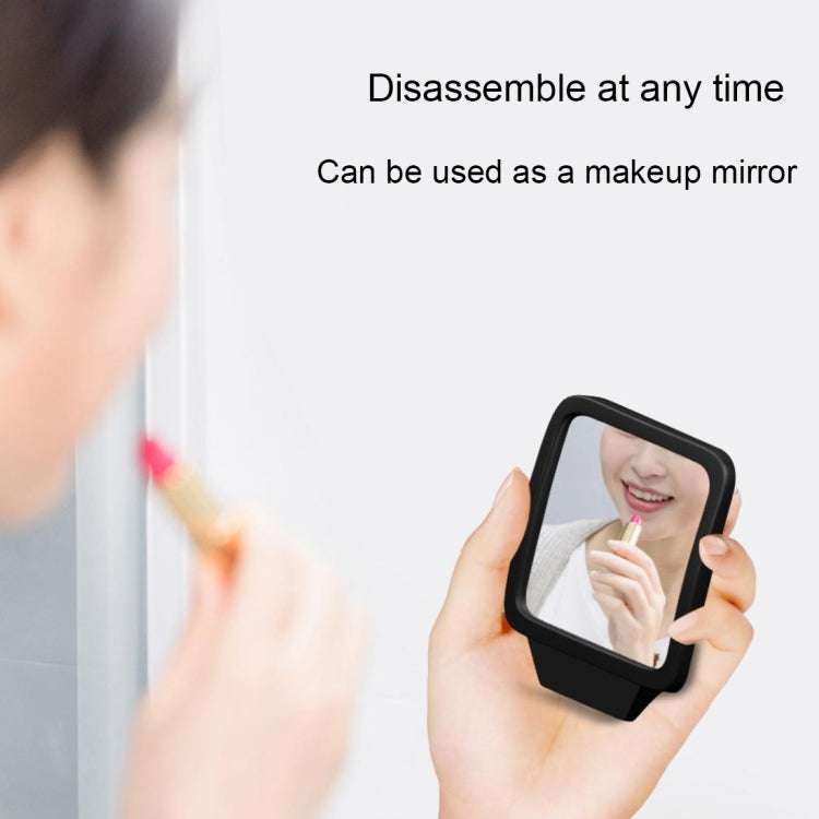 Car blind spot mirror detached, held in hand for vanity reflection