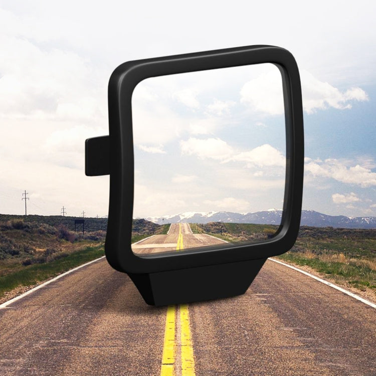 Black wide-angle rearview blind spot mirror on car bracket, road view in glass