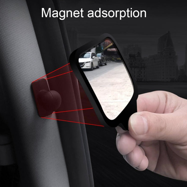 Black magnet mount blind spot mirror held near car interior