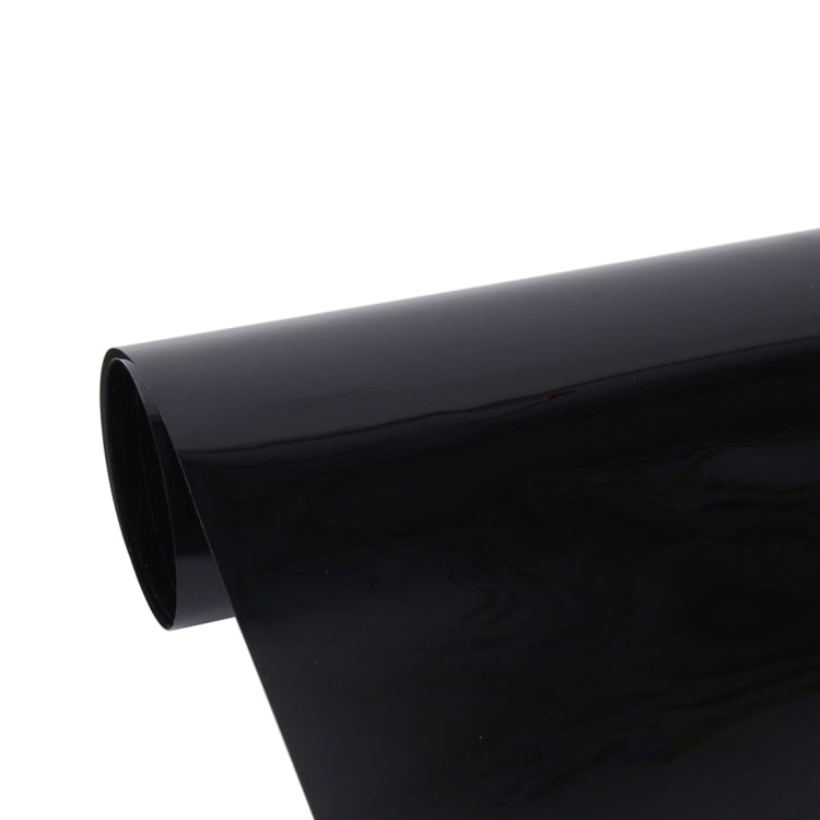Car window tint film roll, close-up of glossy dark edge