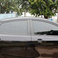 Car side window tint film with dark smoke finish on vehicle door glass