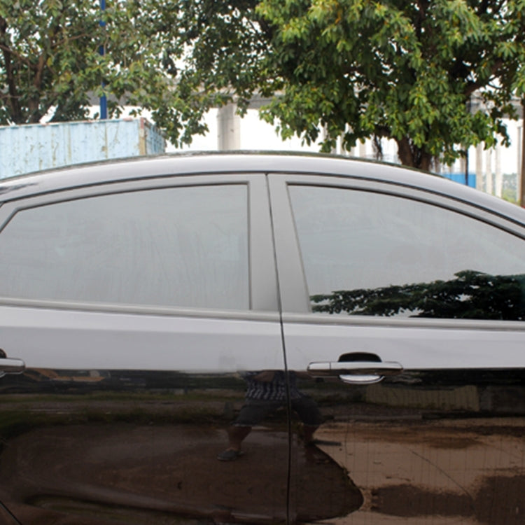 Car side window tint film with dark smoke finish on vehicle door glass