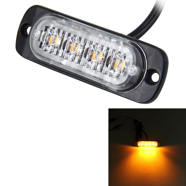 Black-and-clear 4-LED strobe warning light, front lens glowing amber