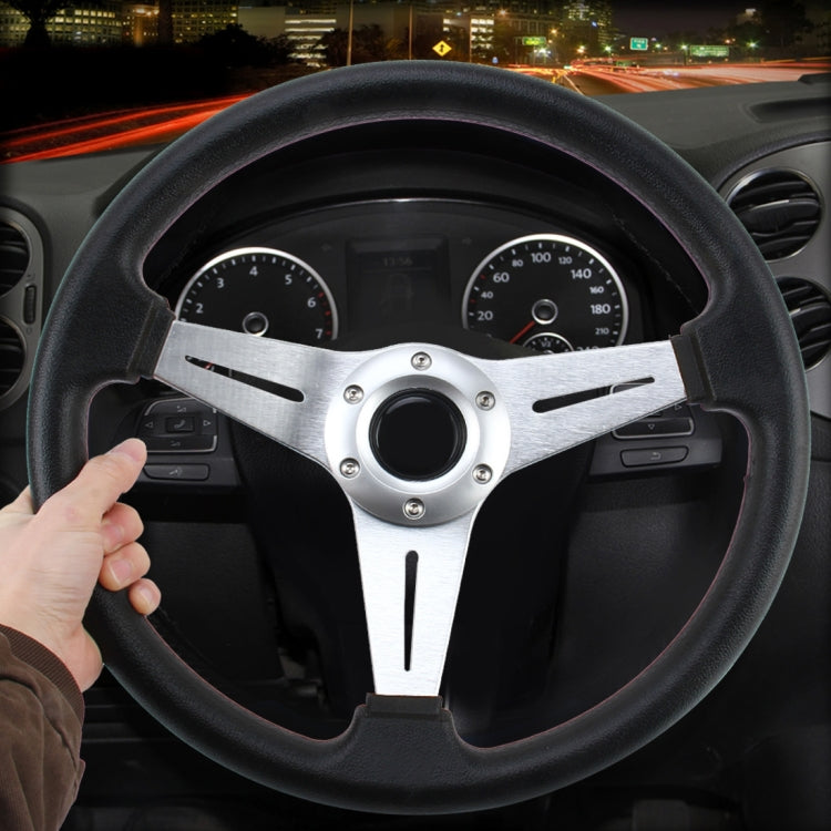 Black PU racing steering wheel with silver spoke trim and central horn pad