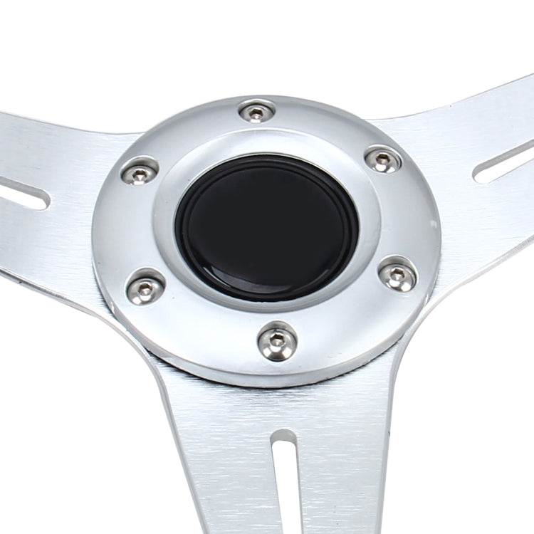 Silver racing steering wheel center with black circular horn pad and bolts