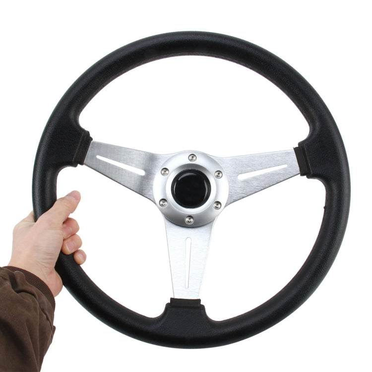 Black PU racing steering wheel with silver spokes and central horn pad