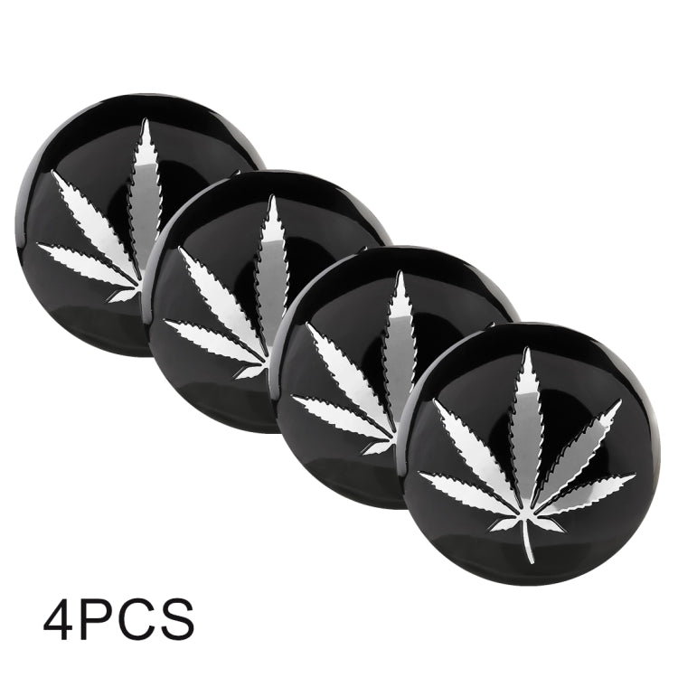 Four-pack round car wheel hub stickers with black face and white leaf burst design