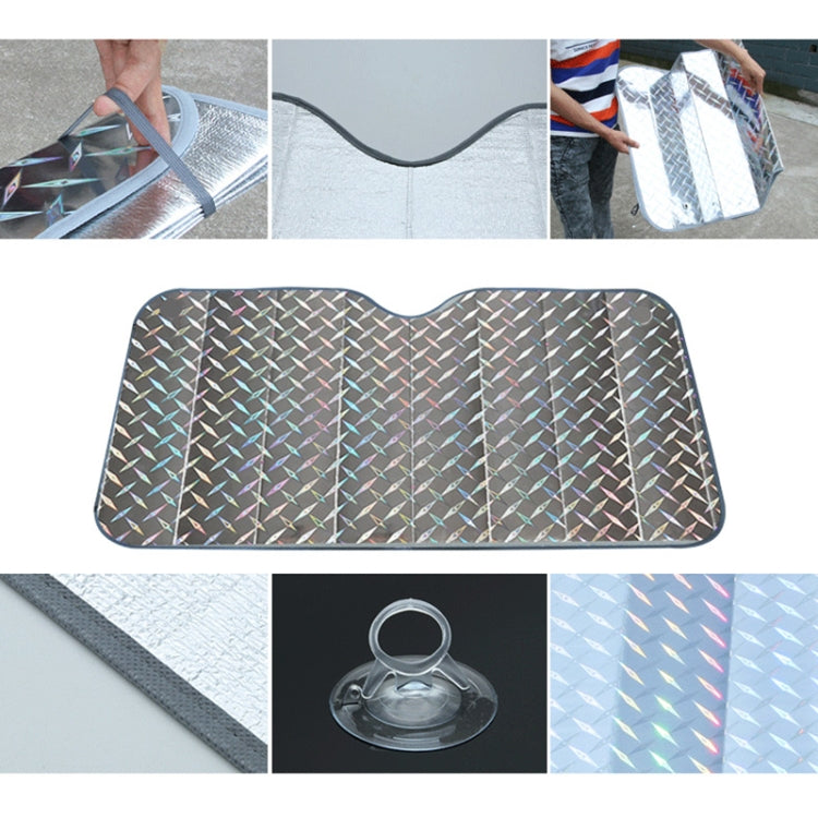 Hatchback windshield sunshade cover being laid on the car, silver-gray diamond foil