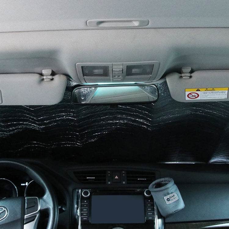 Hatchback windshield sunshade cover installed inside car, suction cups visible