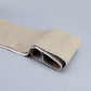 Beige leather steering wheel cover with perforated grip and stitched edge seam