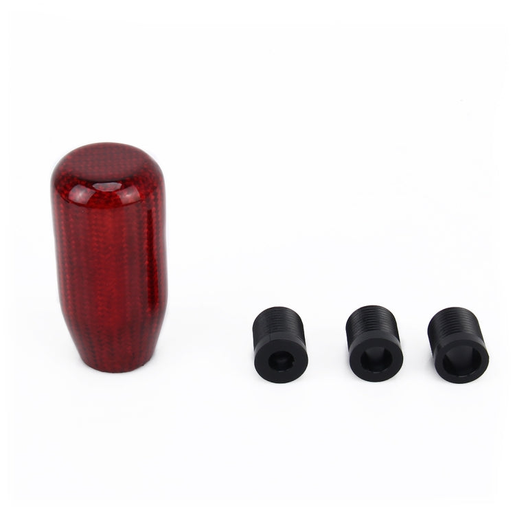 Red carbon-fiber style gear shift knob cover with three black mounting bolts.