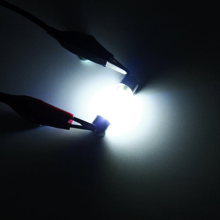 LED car dome light bulbs glowing bright white, compact clear-tube bulbs.