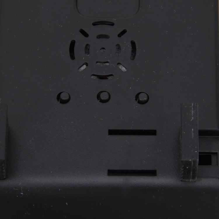 Close-up of car rearview monitor back panel with speaker grille and ports