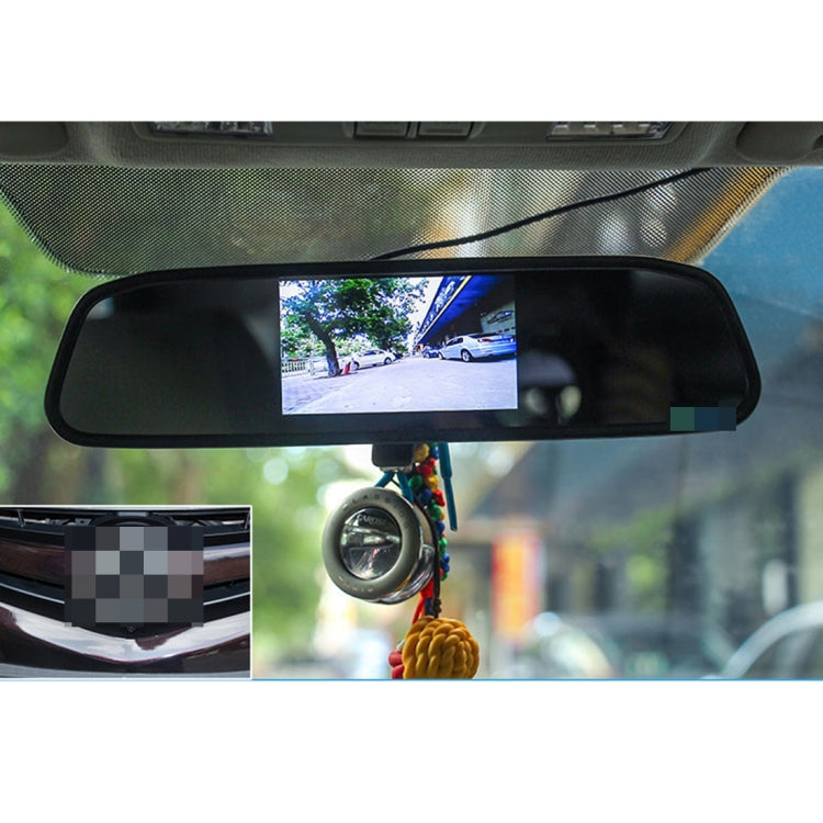 In-car rearview monitor showing reverse camera view on built-in screen