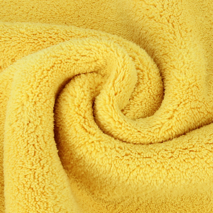 Microfiber cleaning towel fabric close-up, bright yellow fuzzy texture.