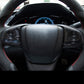 Black steering wheel with red trim stitching and textured center grip