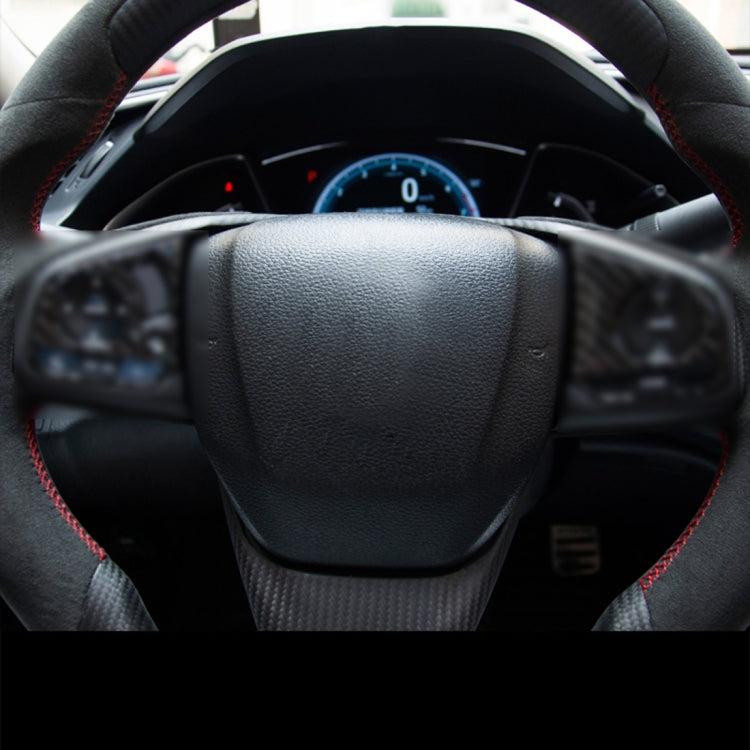 Black steering wheel with red trim stitching and textured center grip