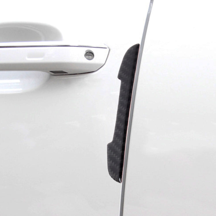 Black carbon fiber door edge guard installed on car door edge, curved protective strip.
