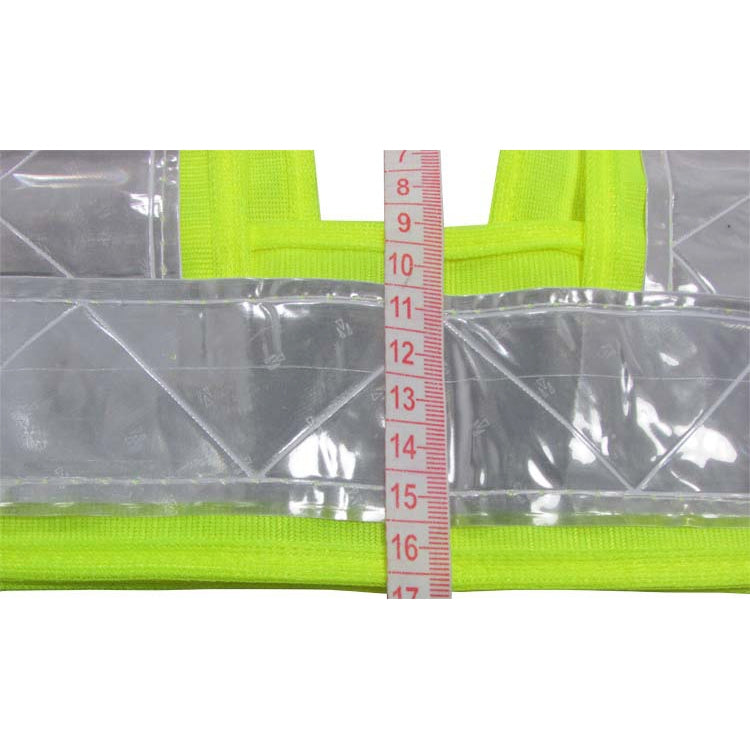 Neon yellow reflective safety vest reflective silver panel beside a measuring ruler