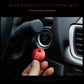 Red engine start stop button cover held near a car ignition start/stop button