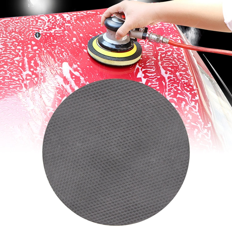 Round black grinding/polishing disk pad with textured surface for car cleaning