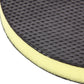 Close-up of round black grinding pad with yellow foam backing and textured face
