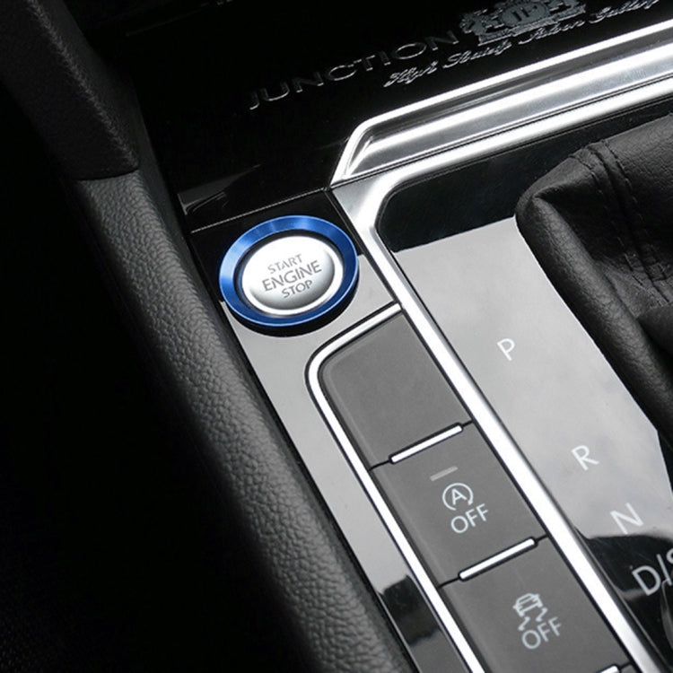 Blue aluminum start/stop button ring trim on car console