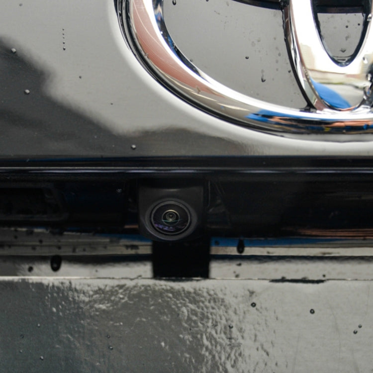 Mounted backup camera lens centered in rear bumper license area