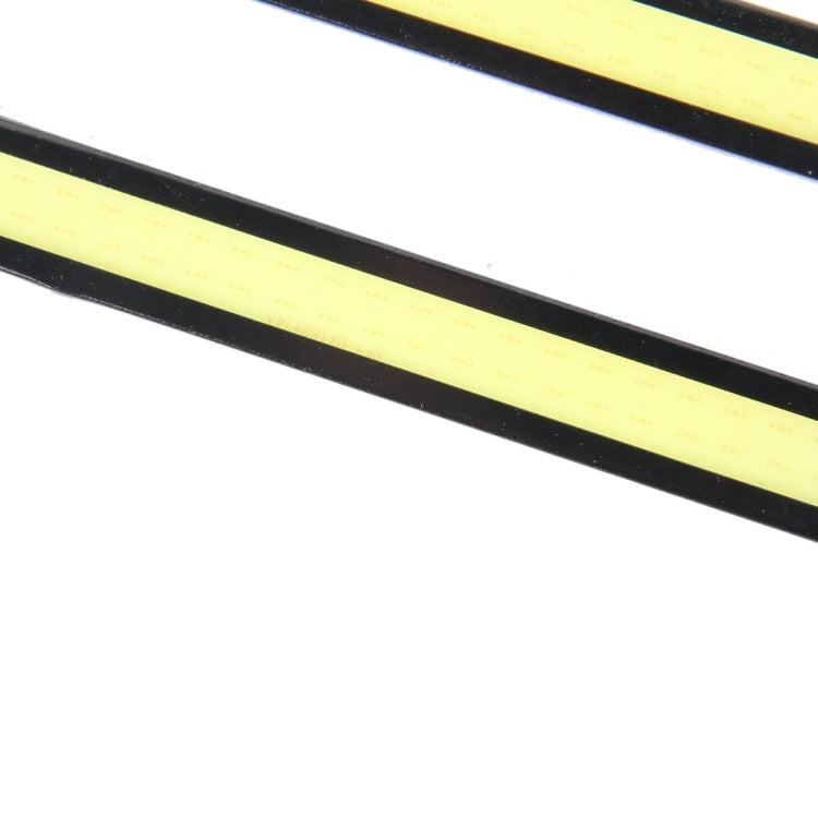 Close-up of yellow COB LED strip inside black DRL light bar