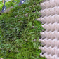 White stackable wall planter with open pockets holding green leafy plants