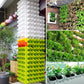 Vertical wall planter system with green and white stackable pockets and plants
