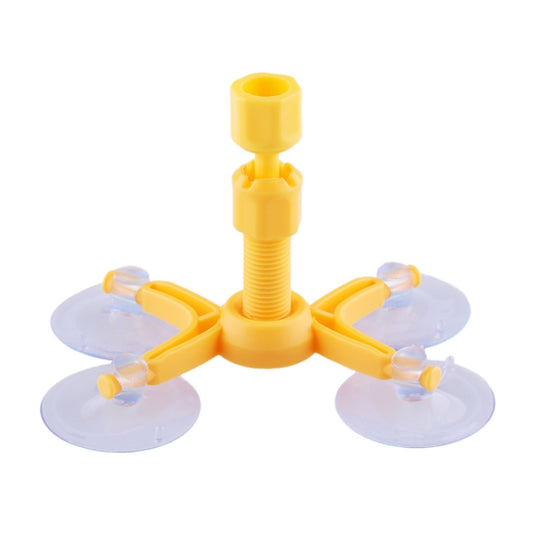 Yellow windshield repair tool base with three suction pads and center stand post