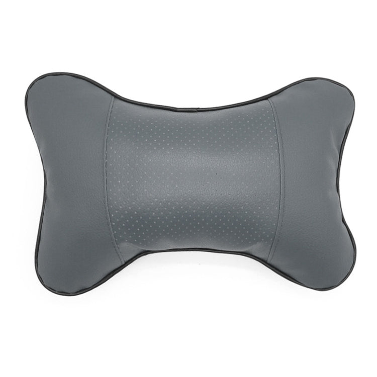 Dark charcoal leather car neck pillow with perforated center and rounded bone shape
