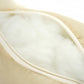 Light beige leather car neck pillow edge with white piping and stitched seam