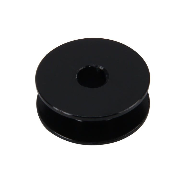 Black anodized bolt cap with center hole and low-profile round design.
