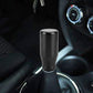 Black gear shift knob for car interior, smooth rounded cylinder