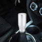 White gear shift knob mounted on automatic transmission lever