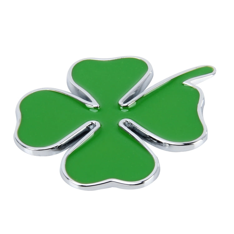 Four-leaf clover emblem sticker with green center and chrome outline, angled view