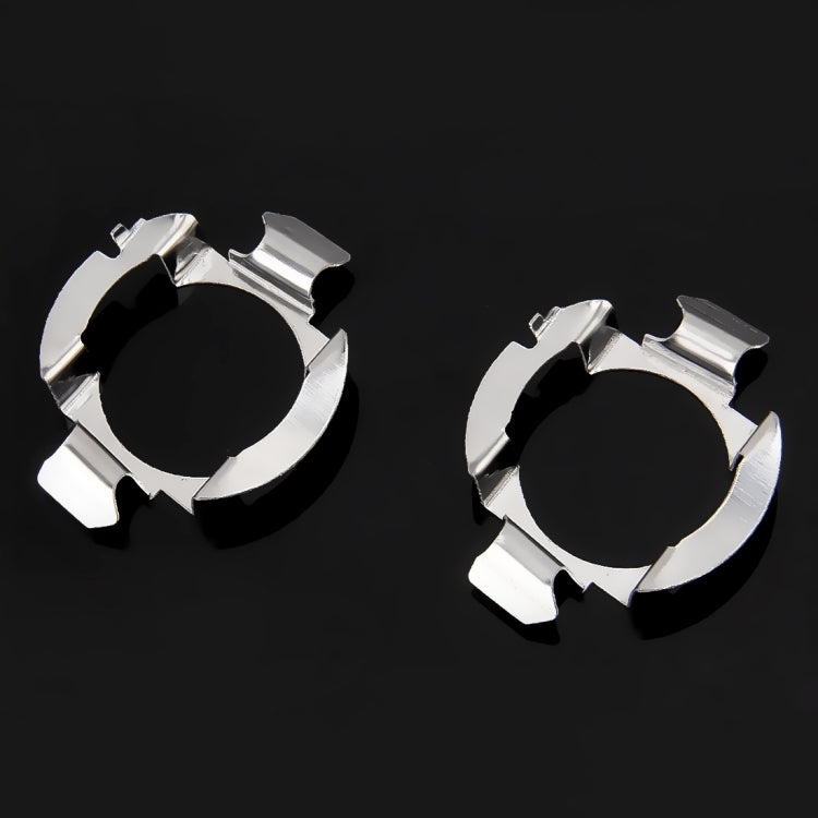 Two chrome metal circular retainer clips with cutout tabs, side view
