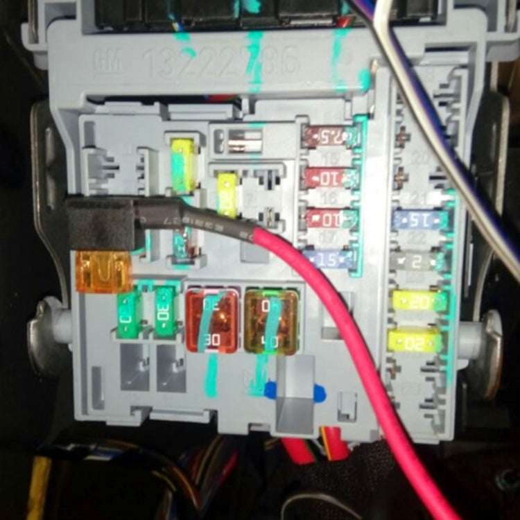Add-a-circuit fuse tap adapter plugged into car fuse box with red wire