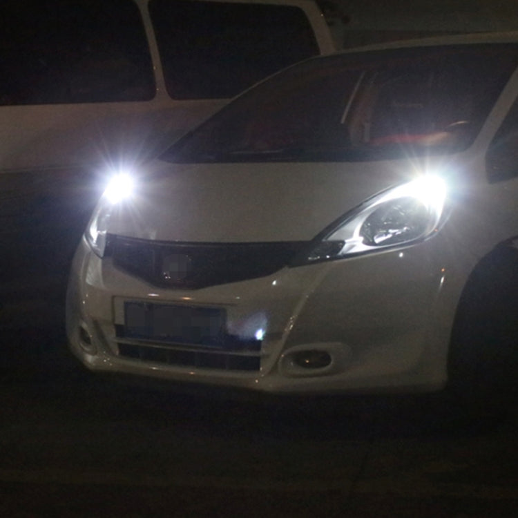 Car front with headlights on; T10 LED bulb glow visible near the light area