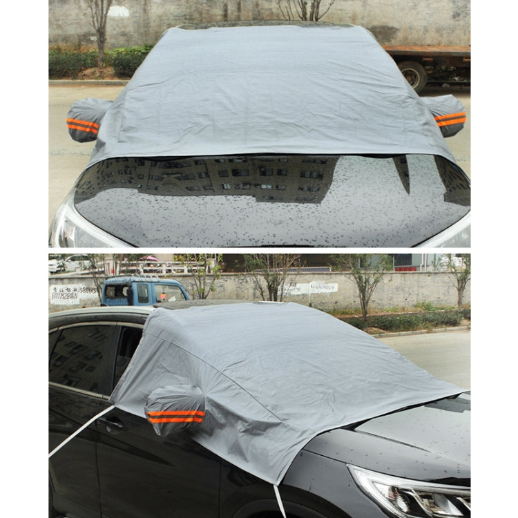 Car windshield snow cover, light gray tarp draped over windshield with reflective orange strip