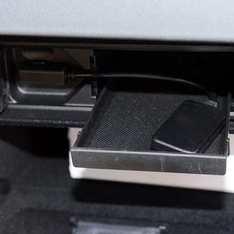 Black audio cable harness in vehicle console bay with connector end