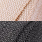 Close-up weave of black and beige exhaust wrap fabric seam