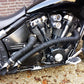 Black exhaust heat wrap installed around motorcycle exhaust pipe and headers