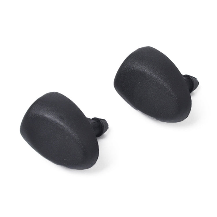 Pair of black windshield washer jet nozzles, angled view with plastic outlets