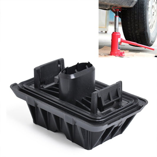 Black plastic jack point support pad with raised gripping tabs and central cylinder