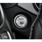 Round silver rhinestone engine start/stop button cover on dark dashboard