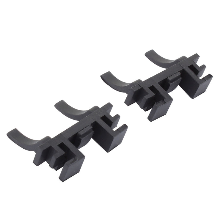 Two black headlight bulb retainer holders with curved spring arms and pins